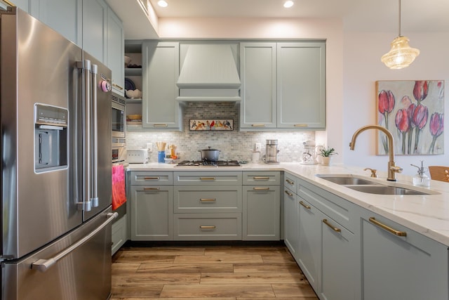 200 Manufacturers Rd Apt 507, Chattanooga, TN 37405 - kitchen featuring appliances with stainless steel finishes, recessed lighting, light wood-style flooring, light stone counters, and decorative backsplash
