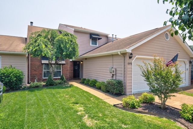 6590 Hickory Brook Rd, Chattanooga, TN 37421 - view of front of house with a front yard, an attached garage, brick siding, and roof with shingles