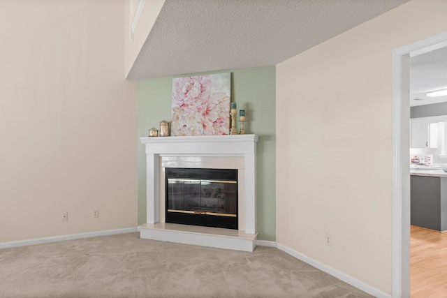 6590 Hickory Brook Rd, Chattanooga, TN 37421 - detailed view of a glass covered fireplace, baseboards, a textured ceiling, and carpet flooring