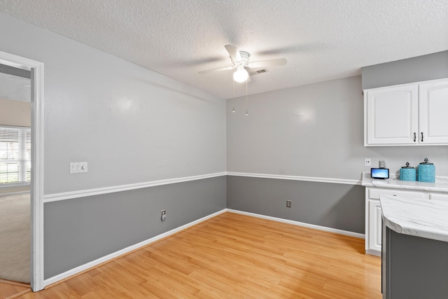 6590 Hickory Brook Rd, Chattanooga, TN 37421 - kitchen with ceiling fan, white cabinetry, light wood-style flooring, a textured ceiling, and baseboards