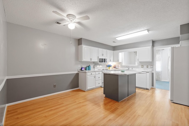 6590 Hickory Brook Rd, Chattanooga, TN 37421 - kitchen featuring white appliances, a textured ceiling, light wood-style flooring, white cabinetry, and a ceiling fan