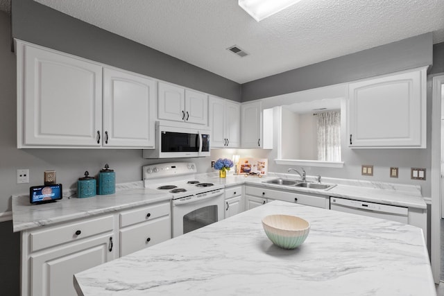 6590 Hickory Brook Rd, Chattanooga, TN 37421 - kitchen featuring white appliances, a sink, white cabinetry, and a textured ceiling