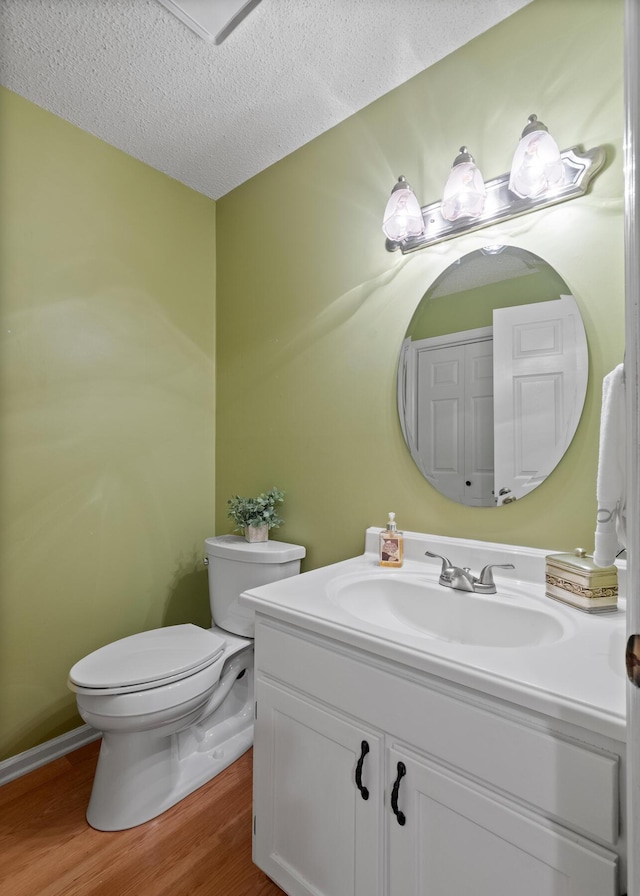 6590 Hickory Brook Rd, Chattanooga, TN 37421 - half bathroom featuring toilet, vanity, wood finished floors, and a textured ceiling