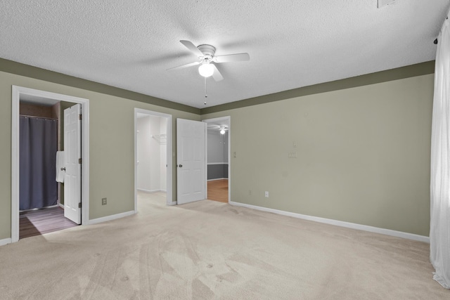 6590 Hickory Brook Rd, Chattanooga, TN 37421 - unfurnished bedroom featuring a walk in closet, light colored carpet, baseboards, a closet, and a textured ceiling