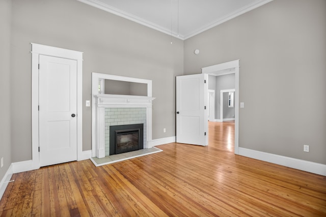 208 E Villanow St, Lafayette, GA 30728 - unfurnished living room with crown molding, a brick fireplace, baseboards, a high ceiling, and light wood-style floors