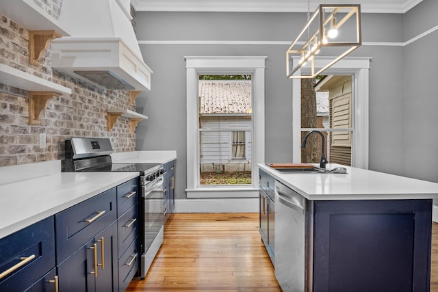 208 E Villanow St, Lafayette, GA 30728 - kitchen with appliances with stainless steel finishes, blue cabinets, a sink, light wood finished floors, and tasteful backsplash