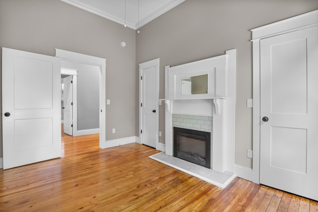 208 E Villanow St, Lafayette, GA 30728 - unfurnished living room featuring ornamental molding, light wood-style floors, baseboards, a high ceiling, and a fireplace
