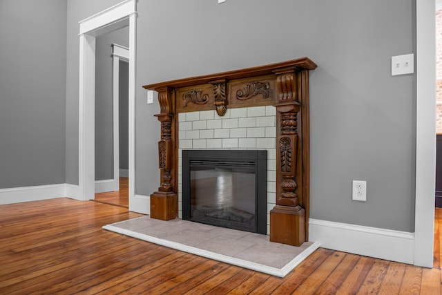 208 E Villanow St, Lafayette, GA 30728 - detailed view of wood finished floors, a tiled fireplace, and baseboards
