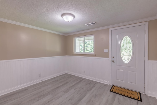 1806 Dallas Lake Rd, Soddy Daisy, TN 37379 - entryway featuring wainscoting, light wood-type flooring, a textured ceiling, and ornamental molding