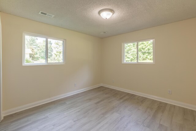 1806 Dallas Lake Rd, Soddy Daisy, TN 37379 - empty room featuring wood finished floors, a textured ceiling, and baseboards