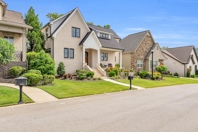 9257 Skyfall Dr, Ooltewah, TN 37363 - view of front facade with a front lawn, brick siding, roof with shingles, and stone siding