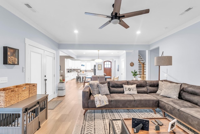 9257 Skyfall Dr, Ooltewah, TN 37363 - living area featuring stairway, ceiling fan, light wood-type flooring, recessed lighting, and ornamental molding