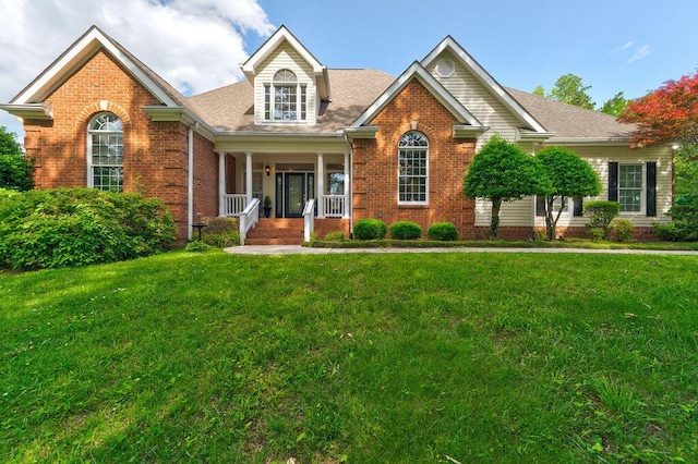 81 Arnold Rd, Rock Spring, GA 30739 - view of front of property featuring a porch, brick siding, a front yard, and a shingled roof