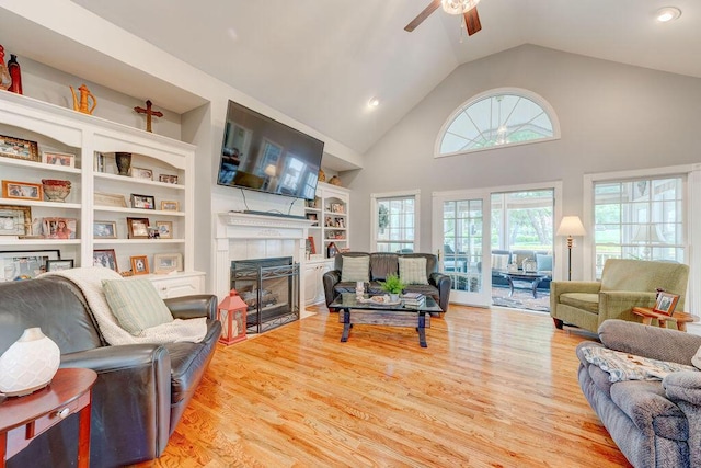 81 Arnold Rd, Rock Spring, GA 30739 - living room with a ceiling fan, a tile fireplace, wood finished floors, built in shelves, and high vaulted ceiling