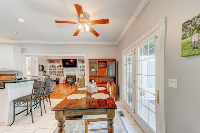 81 Arnold Rd, Rock Spring, GA 30739 - dining room featuring ornamental molding, ceiling fan, a fireplace, and light tile patterned floors