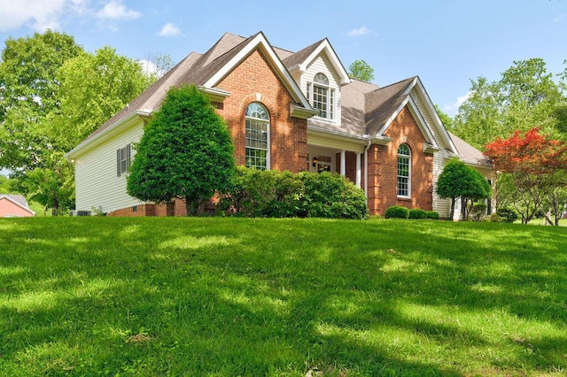 81 Arnold Rd, Rock Spring, GA 30739 - view of front of home featuring brick siding, a front yard, and roof with shingles