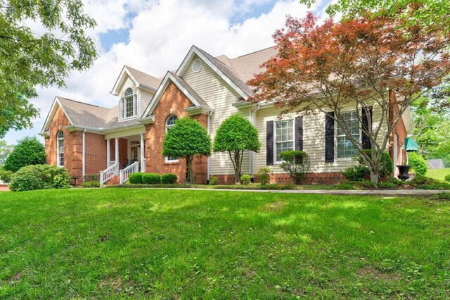 81 Arnold Rd, Rock Spring, GA 30739 - view of front of house with brick siding, a front lawn, and a shingled roof