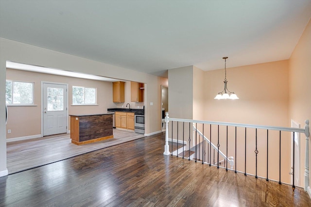1373 Meadowood Dr, Hixson, TN 37343 - kitchen featuring dark countertops, dark wood-type flooring, a sink, a chandelier, and baseboards