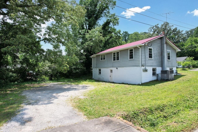 1204 Greenwood Rd, Chattanooga, TN 37411 - view of home's exterior featuring a yard, metal roof, and central AC