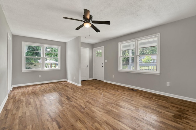 1204 Greenwood Rd, Chattanooga, TN 37411 - spare room with wood finished floors, plenty of natural light, a ceiling fan, and a textured ceiling