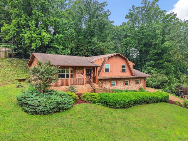 787 Flinn Dr, Chattanooga, TN 37412 - split level home with a gambrel roof, covered porch, and brick siding