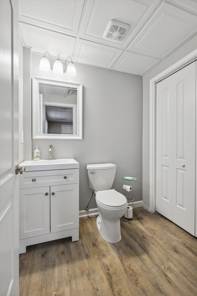 787 Flinn Dr, Chattanooga, TN 37412 - bathroom with toilet, vanity, baseboards, and wood finished floors