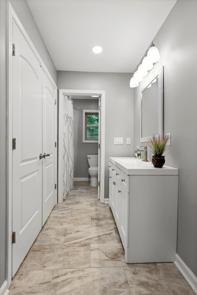 787 Flinn Dr, Chattanooga, TN 37412 - bathroom with vanity, toilet, baseboards, marble finish floors, and recessed lighting