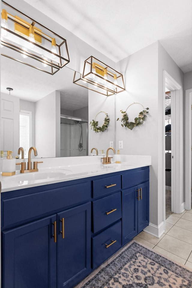 236 Stanford Dr, Flintstone, GA 30725 - bathroom featuring double vanity, a stall shower, tile patterned flooring, baseboards, and a chandelier