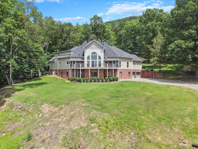 310 Bluffs Rd N, South Pittsburg, TN 37380 - back of property with brick siding, driveway, a garage, a forest view, and a lawn