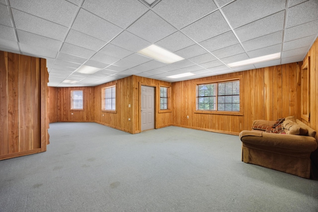310 Bluffs Rd N, South Pittsburg, TN 37380 - carpeted living area with healthy amount of natural light, wood walls, a drop ceiling, and baseboards