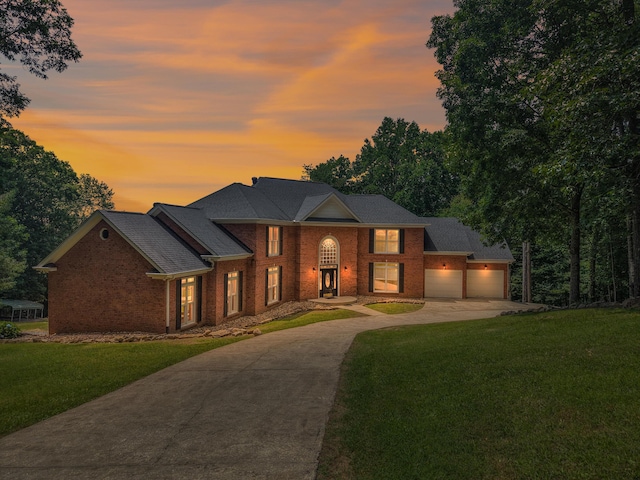 310 Bluffs Rd N, South Pittsburg, TN 37380 - view of front of house with driveway, brick siding, a front lawn, and an attached garage