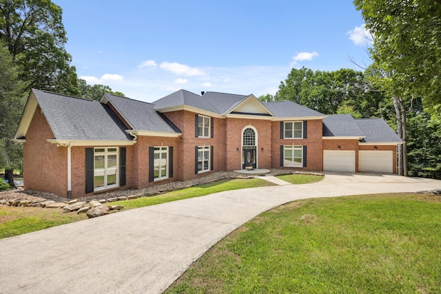 310 Bluffs Rd N, South Pittsburg, TN 37380 - view of front of house featuring concrete driveway, brick siding, a garage, and a front lawn