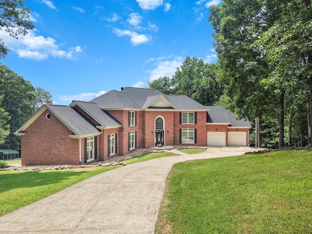 310 Bluffs Rd N, South Pittsburg, TN 37380 - view of front of house with driveway, brick siding, a front lawn, and an attached garage