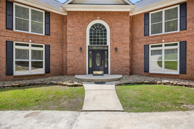 310 Bluffs Rd N, South Pittsburg, TN 37380 - view of exterior entry featuring brick siding, a yard, and roof with shingles