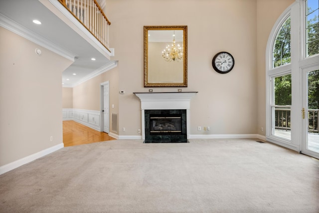 310 Bluffs Rd N, South Pittsburg, TN 37380 - unfurnished living room featuring a high ceiling, carpet floors, ornamental molding, a fireplace, and recessed lighting
