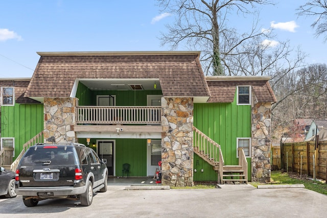 32 S Germantown Rd, Chattanooga, TN 37411 - front facade featuring board and batten siding, mansard roof, stone siding, a balcony, and stairway