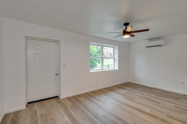 304 Gillespie Rd, Chattanooga, TN 37411 - empty room featuring an AC wall unit, a ceiling fan, light wood-style floors, and baseboards