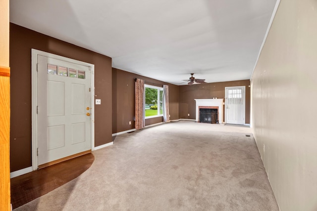 2524 Spring Place Rd SE, Cleveland, TN 37323 - unfurnished living room with carpet, ceiling fan, plenty of natural light, and a fireplace