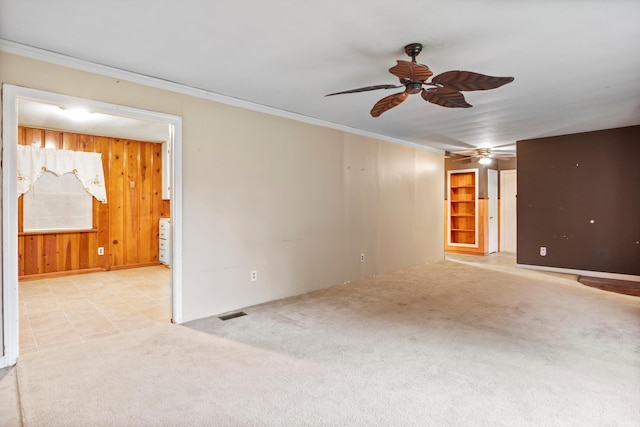 2524 Spring Place Rd SE, Cleveland, TN 37323 - empty room featuring ceiling fan, crown molding, wooden walls, and light carpet