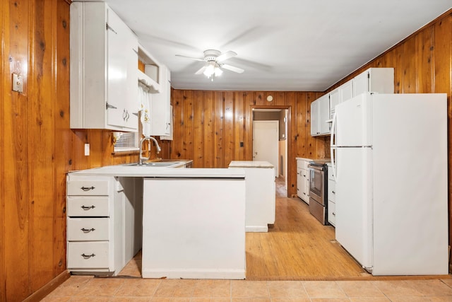 2524 Spring Place Rd SE, Cleveland, TN 37323 - kitchen featuring freestanding refrigerator, a sink, electric range, ceiling fan, and wooden walls