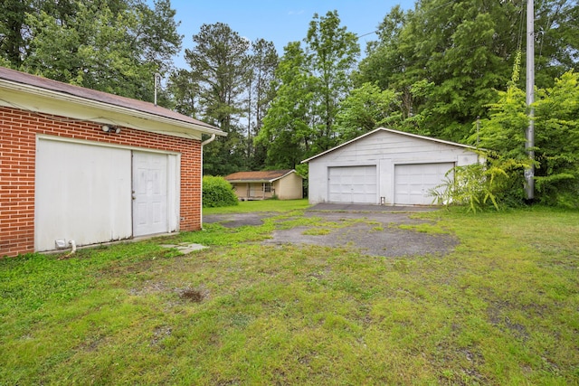 2524 Spring Place Rd SE, Cleveland, TN 37323 - view of grassy yard featuring an outdoor structure, a garage, and view of wooded area