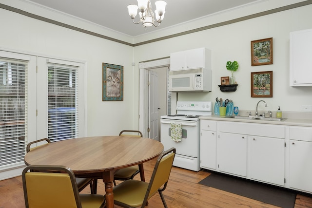 602 Oliver St, Chattanooga, TN 37405 - kitchen with white appliances, a chandelier, ornamental molding, white cabinetry, and light countertops