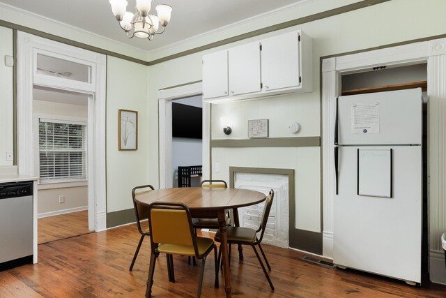 602 Oliver St, Chattanooga, TN 37405 - dining room with a chandelier, crown molding, and dark wood-style flooring