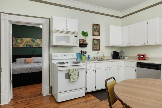 602 Oliver St, Chattanooga, TN 37405 - kitchen with white appliances, ornamental molding, wood finished floors, white cabinets, and light countertops