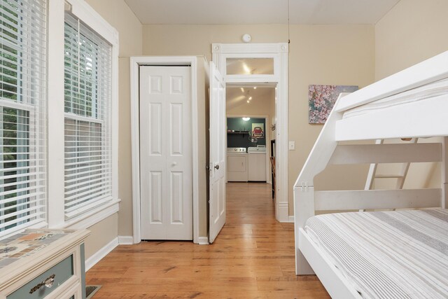 602 Oliver St, Chattanooga, TN 37405 - bedroom with washing machine and dryer, light wood-style flooring, and a closet