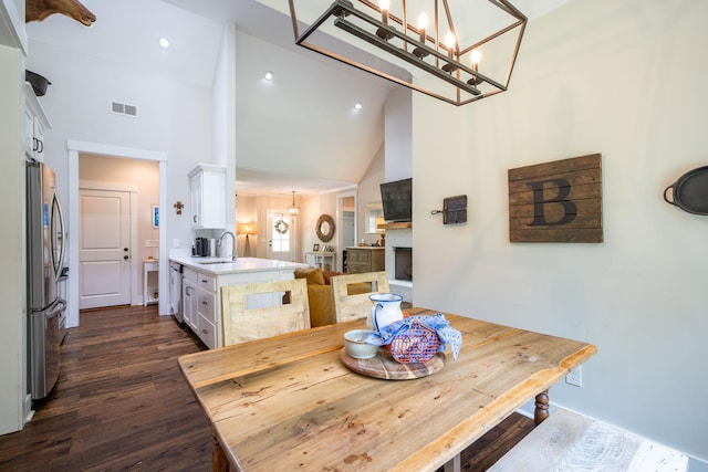 2024 Oak St, Signal Mountain, TN 37377 - dining space featuring high vaulted ceiling, a chandelier, dark wood-style floors, recessed lighting, and a fireplace