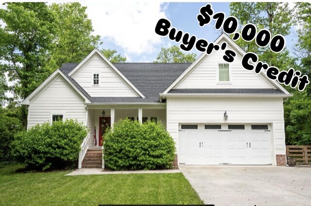 2024 Oak St, Signal Mountain, TN 37377 - view of front facade with concrete driveway, a front lawn, an attached garage, and covered porch