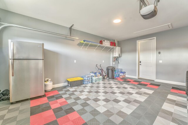 329 Kempton Ln, Dalton, GA 30721 - garage with freestanding refrigerator, a garage door opener, and baseboards