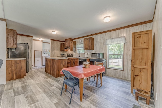 1005 Cohutta Beaverdale Rd, Cohutta, GA 30710 - dining area with light wood finished floors, washer and dryer, and crown molding