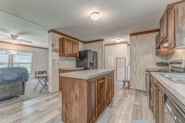 1005 Cohutta Beaverdale Rd, Cohutta, GA 30710 - kitchen with stainless steel appliances, light wood-type flooring, light countertops, brown cabinets, and a textured ceiling